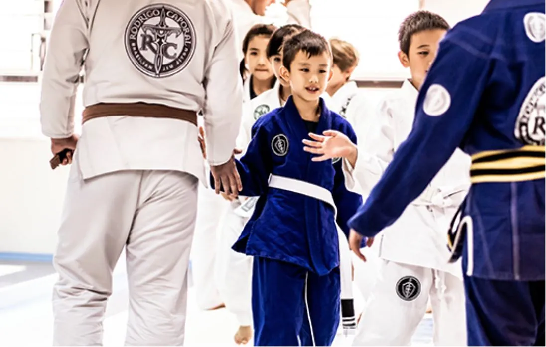 Kids high-fiving the coaches after class